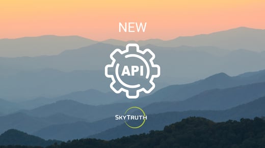 A background photo showing the silhouette of the Appalachian Mountains at dusk. The image is overlaid with three things vertically in the center: the word “NEW” and a gear icon representing an API, both in white, with the SkyTruth logo beneath.
