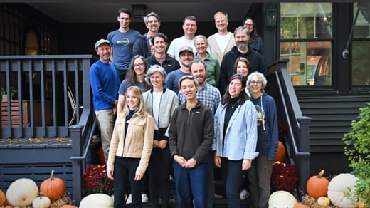A group photograph of the SkyTruth team showing them standing on the stairs of a large porch. 